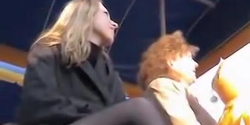 Public upskirt of the blonde with crossed legs in stockings